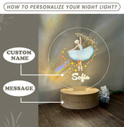 a light up ballerina on a wooden base