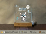 a glass plaque with a picture of a little fox on it