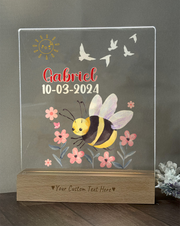 a glass plaque with a picture of a bee on it