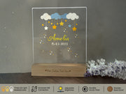a clear acrylic plaque with stars and clouds