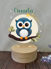 a blue owl sitting on top of a tree branch