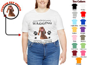 a white t - shirt with a dog's face and paw prints