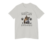 a white t - shirt with a cat saying it's not lazy, just