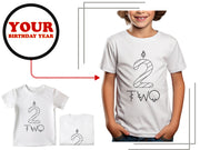 a young boy wearing a two year birthday t - shirt