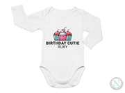 a white bodysuit with a cupcake design on it