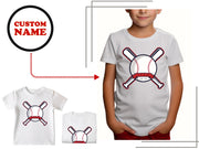 a child's t - shirt with a baseball bat and ball on it