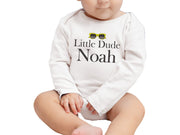 a baby wearing a little dude noah onesie