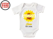 a baby bodysuit with a sunflower on it