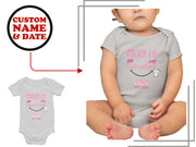 a baby bodysuit with a smiley face on it