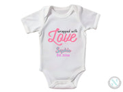 a baby bodysuit with the words, wrapped with love
