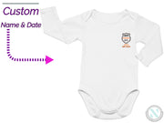 a white long sleeved bodysuit with a badge on the chest