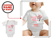 a white bodysuit with a tree and name on it