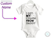 a baby bodysuit with the words i get my charm from daddy on it
