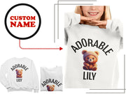 a woman wearing a white shirt with a teddy bear on it