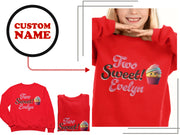 a woman wearing a red shirt with a cupcake on it