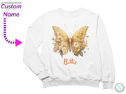 a white sweatshirt with a yellow butterfly on it