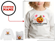 a girl wearing a white shirt with a pumpkin on it