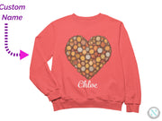 a pink sweater with a heart made out of circles