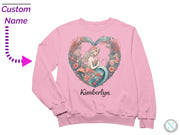 a pink sweatshirt with a mermaid heart on it