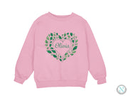 a pink sweatshirt with a heart and leaves on it