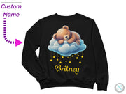 a black sweater with a teddy bear sleeping on a cloud