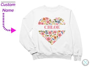 a white sweatshirt with a floral heart and name