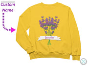 a yellow sweatshirt with a bunch of purple flowers on it