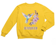 a yellow sweatshirt with a hummingbird and flowers on it