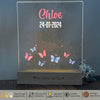 a glass plaque with a picture of butterflies on it