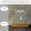 a personalized glass block with a name and a picture of a necklace