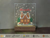 a glass block with a gingerbread house on it