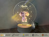 a small elephant on a stand with a name on it