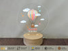 a glass globe with a hot air balloon on it