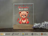 a clear acrylic with a teddy bear holding a heart