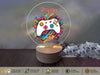 a white game controller on top of a wooden stand