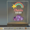 a clear acrylic sign with a star and a rainbow