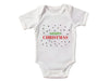 a white bodysuit with merry christmas written on it