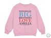 a pink sweatshirt with the words, powered by big brother&#39;s love ameli
