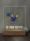 a glass block with the letter k is for kevin